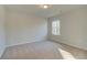 Carpeted bedroom with natural lighting and a large window at 125 Belvedere Rd, Mcdonough, GA 30253