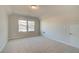Bright, carpeted bedroom with large windows, offering a serene space with natural light and backyard views at 125 Belvedere Rd, Mcdonough, GA 30253