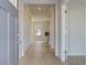 Bright hallway with hardwood floors leads to an open-concept living space with a modern fireplace and natural light at 125 Belvedere Rd, Mcdonough, GA 30253