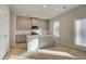 Modern kitchen features center island with sink, stainless appliances, and an abundance of natural light at 125 Belvedere Rd, Mcdonough, GA 30253