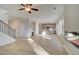 Expansive living area flows into kitchen, featuring sleek fireplace, wood floors, and ample natural light at 125 Belvedere Rd, Mcdonough, GA 30253