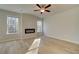 Bright living room with sleek, modern fireplace and large windows providing ample natural light and wooded views at 125 Belvedere Rd, Mcdonough, GA 30253