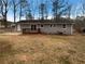 Backyard featuring a wooden deck, a yard, and a grey siding house with a dark roof at 1963 Suwanee Ter, Lawrenceville, GA 30043