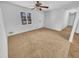 Clean, light-filled living room with a ceiling fan and neutral carpet at 1963 Suwanee Ter, Lawrenceville, GA 30043