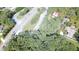 The aerial view showcases the property near a winding road and a variety of houses at 4671 Collins Ave, Acworth, GA 30101