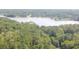 The aerial view captures the serene lake and lush trees surrounding the property at 4671 Collins Ave, Acworth, GA 30101