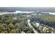 The aerial view shows the lake and a variety of houses surrounded by trees at 4671 Collins Ave, Acworth, GA 30101