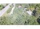 This aerial view showcases the property's mature trees next to a road and other homes at 4671 Collins Ave, Acworth, GA 30101