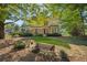 Charming two-story home with a covered front porch and well-manicured lawn surrounded by mature trees at 4671 Collins Ave, Acworth, GA 30101