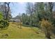 Expansive backyard with mature trees, offering privacy and a connection to nature at 1366 Emory Ne Rd, Atlanta, GA 30306