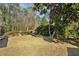 A shady backyard with mature trees and shrubs, complemented by a well-maintained lawn at 1366 Emory Ne Rd, Atlanta, GA 30306
