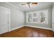 Empty bedroom featuring hardwood floors and light streaming through a wall of windows at 1366 Emory Ne Rd, Atlanta, GA 30306