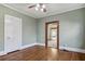 Neutral bedroom with wood floors, large windows, and views to another room at 1366 Emory Ne Rd, Atlanta, GA 30306