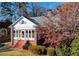 Charming brick home with a sunroom, red stairs, and mature landscaping at 1366 Emory Ne Rd, Atlanta, GA 30306