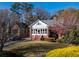 Charming brick home featuring a sunroom, manicured lawn, and mature landscaping at 1366 Emory Ne Rd, Atlanta, GA 30306
