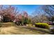 Lush front yard with vibrant landscaping and mature trees providing shade at 1366 Emory Ne Rd, Atlanta, GA 30306