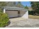 Detached garage featuring an open layout, concrete flooring, and white brick walls at 1366 Emory Ne Rd, Atlanta, GA 30306