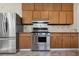 Kitchen featuring stainless steel appliances, wooden cabinets and tile backsplash at 1366 Emory Ne Rd, Atlanta, GA 30306