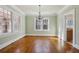 Living room with chandelier, beautiful windows, and hardwood floors at 1366 Emory Ne Rd, Atlanta, GA 30306