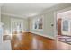 Open living area with hardwood floors, large windows, and access to a sunroom at 1366 Emory Ne Rd, Atlanta, GA 30306