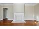 Living room featuring a decorative fireplace, hardwood floors, and neutral paint at 1366 Emory Ne Rd, Atlanta, GA 30306
