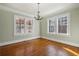 Bright living room with chandelier, beautiful windows, and hardwood floors at 1366 Emory Ne Rd, Atlanta, GA 30306
