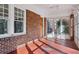 Bright sunroom featuring brick accent wall, tile flooring, and lots of natural light from large windows at 1366 Emory Ne Rd, Atlanta, GA 30306