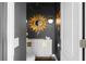 Stylish powder room with a dark accent wall and gold mirror at 3475 Oak Valley Rd # 2820, Atlanta, GA 30326