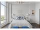 Elegant bedroom with a white bed, featuring floor-to-ceiling windows at 3475 Oak Valley Rd # 2820, Atlanta, GA 30326