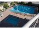 Aerial shot of the community pool and hot tub with lounge chairs, tables and landscaping at 3475 Oak Valley Rd # 2820, Atlanta, GA 30326