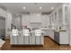 Modern white kitchen with an island, stainless steel appliances, and white subway tile backsplash at 5080 Riverlake Dr, Peachtree Corners, GA 30097