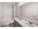 Updated bathroom with double vanity and grey cabinets at 5423 Flat Rock Pt, Stonecrest, GA 30038