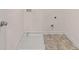 Bright laundry room with vinyl flooring and built-in drain at 5423 Flat Rock Pt, Stonecrest, GA 30038