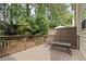 Private outdoor back deck with wood railing overlooking a wooded backyard at 1801 Liberty Nw Pkwy, Atlanta, GA 30318