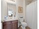 Bathroom with a vanity, mirror, and a toilet with a white shower curtain at 1801 Liberty Nw Pkwy, Atlanta, GA 30318