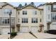 Charming townhome featuring an attached garage, neutral siding, and well maintained landscaping at 1801 Liberty Nw Pkwy, Atlanta, GA 30318