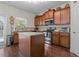 Traditional kitchen features wood cabinets, stainless steel appliances and a granite island at 1801 Liberty Nw Pkwy, Atlanta, GA 30318