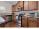 Kitchen boasts stainless steel appliances, granite countertops, and ample wood cabinetry at 1801 Liberty Nw Pkwy, Atlanta, GA 30318