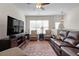 Inviting living room featuring neutral walls, a ceiling fan, and large windows at 1801 Liberty Nw Pkwy, Atlanta, GA 30318