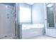 Bright bathroom features a separate shower and soaking tub near a window at 295 Whitby Dr, Douglasville, GA 30134