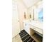Bathroom features a white vanity with a mirror and decorative floor mat at 295 Whitby Dr, Douglasville, GA 30134