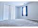 This spacious bedroom features a large window, closet, and neutral carpeting at 295 Whitby Dr, Douglasville, GA 30134