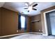 This bedroom features neutral carpet, window with curtains, ceiling fan, and closet at 295 Whitby Dr, Douglasville, GA 30134