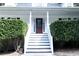 Elegant front entrance with a red door and well-manicured shrubs on either side at 295 Whitby Dr, Douglasville, GA 30134