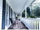 A peaceful covered front porch with chairs, railings, and great natural light at 295 Whitby Dr, Douglasville, GA 30134