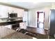 A kitchen with granite countertops, tile floors, stainless steel appliances, and white cabinets at 295 Whitby Dr, Douglasville, GA 30134