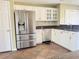 A bright kitchen with white cabinets, stainless steel appliances and granite countertops at 295 Whitby Dr, Douglasville, GA 30134