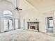 Spacious living room with vaulted ceiling, fireplace, carpet, and French doors to the outside at 295 Whitby Dr, Douglasville, GA 30134