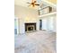 Open living room boasts a fireplace, plush carpeting, and a view to an upstairs landing at 295 Whitby Dr, Douglasville, GA 30134