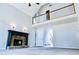 Bright open floor plan featuring a fireplace, carpet, and upstairs landing overlooking the living area at 295 Whitby Dr, Douglasville, GA 30134